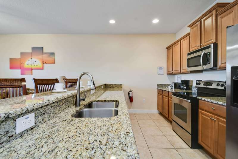 This large galley-style kitchen has granite counter tops, stainless appliances, and about everything you need to prepare a wonderful meal.