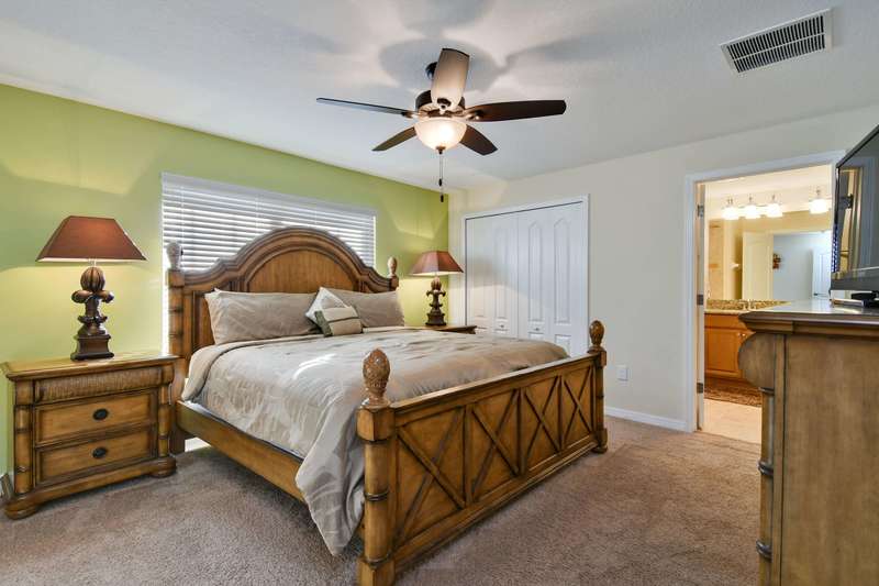 Located on the second floor, this master suite provides spacious and restful accommodation, with a king size bed, nightstands with lamps, dresser, flat-screen LCD TV, a walk-in closet, and a private bathroom suite.