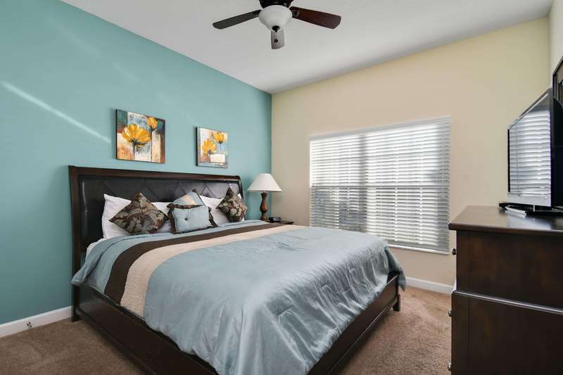 This master bedroom is located off the entrance hallway on the first floor and offers a king-size bed, nightstands and lamps, a dresser with flat-screen LCD TV and an en-suite bathroom.