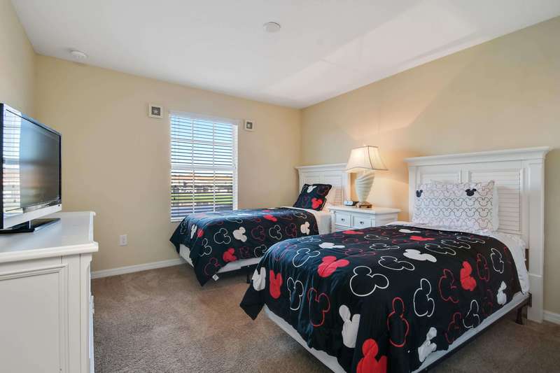 This twin bedroom is perfect for the kids, with 2 twin beds, a nightstand with lamp, a dresser with flat-panel LCD TV, closet space and an adjacent family bathroom.