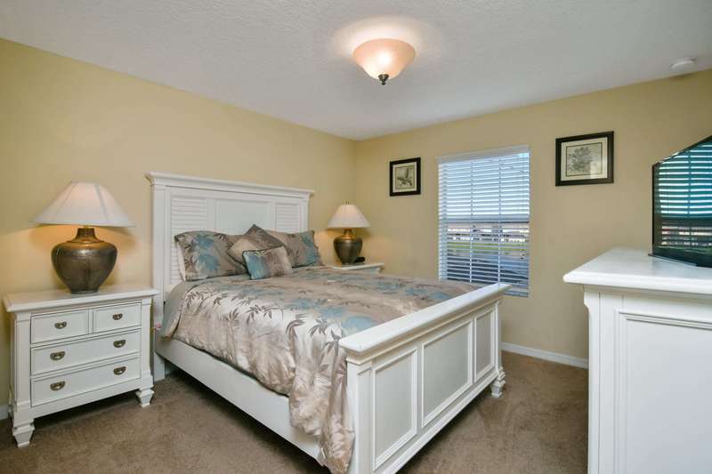 Also located on the second floor, this bedroom features a queen size bed, nightstands with lamps, a dresser with flat-screen cable TV, closet space and a ceiling fan. It shares a family bathroom with the children's bedroom across the hall.
